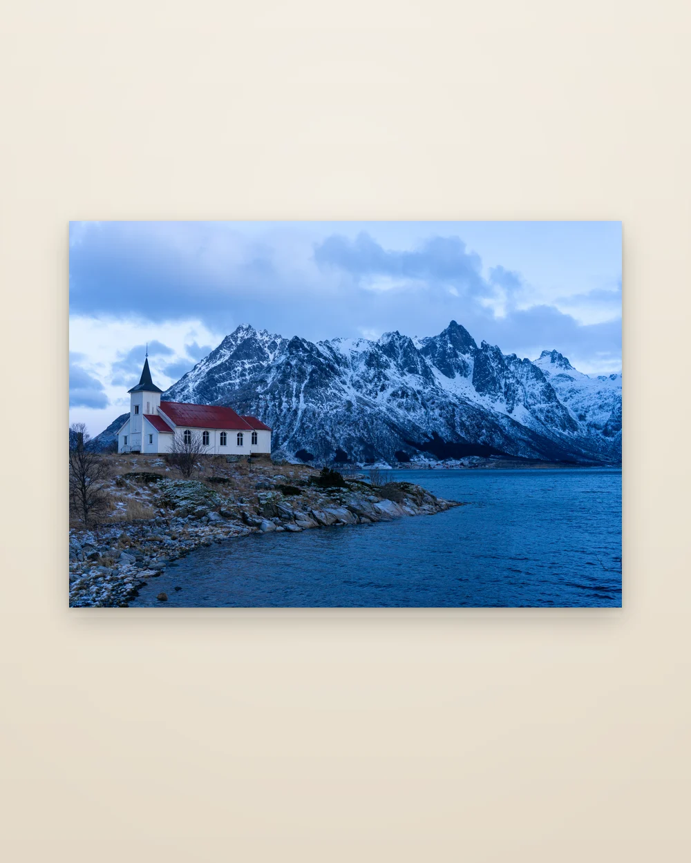 The aluminium print of The Church, frameless, shown whole: a white church with a red roof on a rocky shore, snowy Lofoten peaks behind
