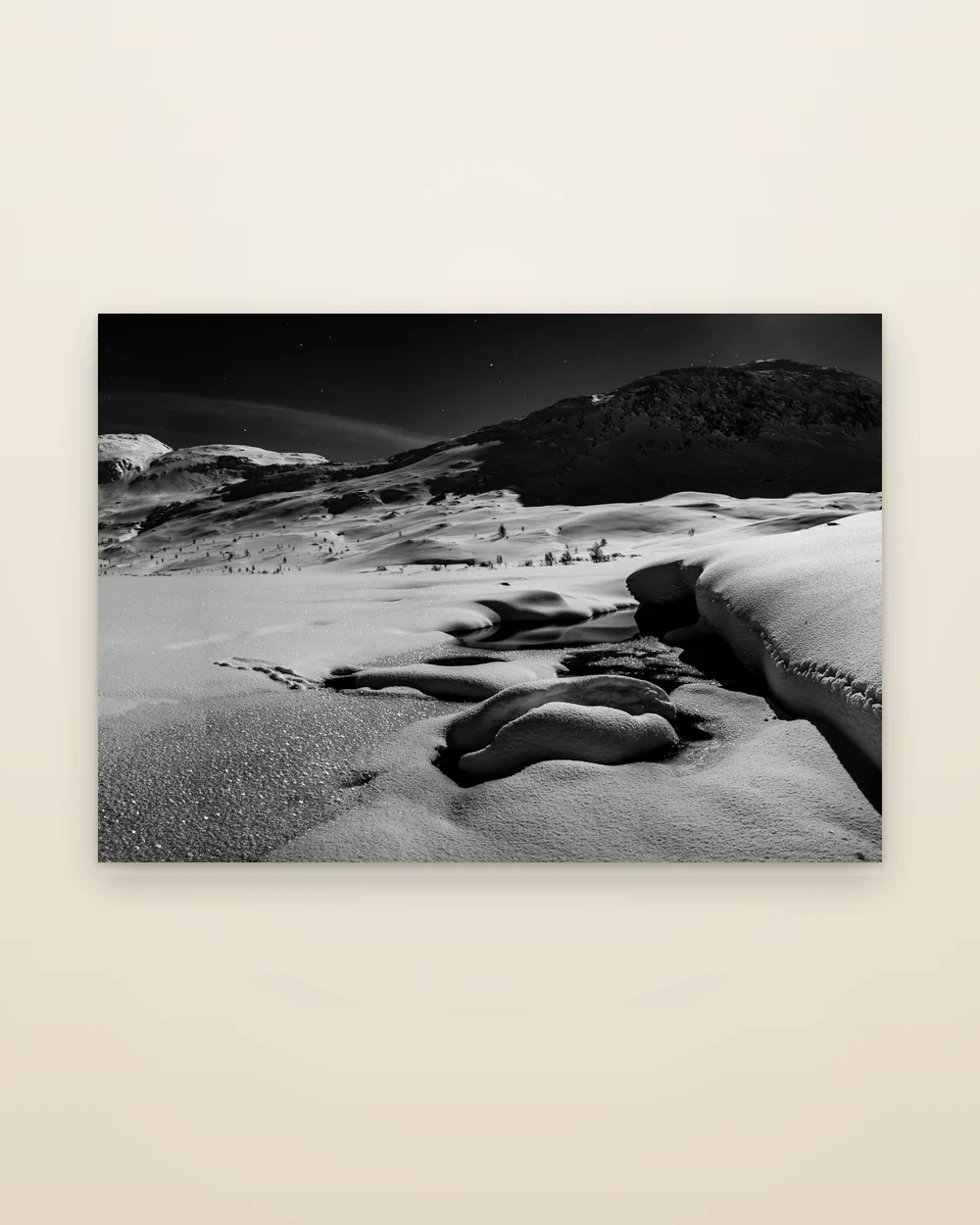 The aluminium print of Moonlight, frameless, shown whole: moonlit snow below a dark mountain and stars